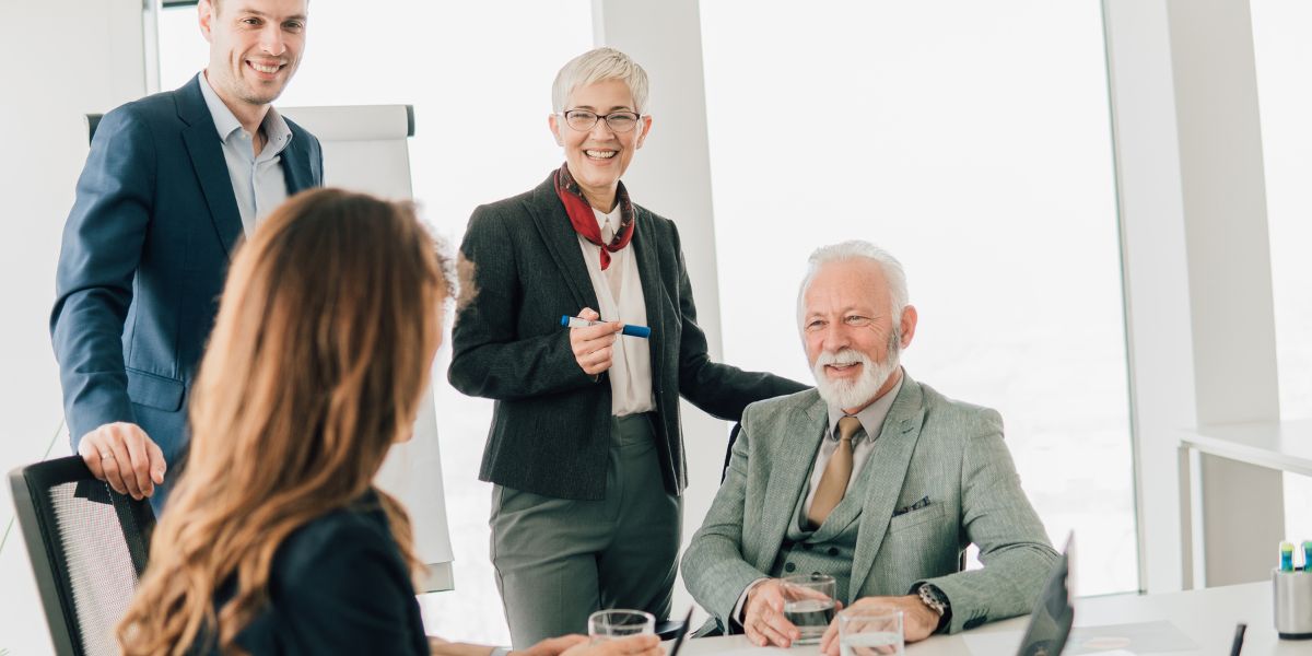Group of professionals having a discussion during an estate planning meeting in an office.