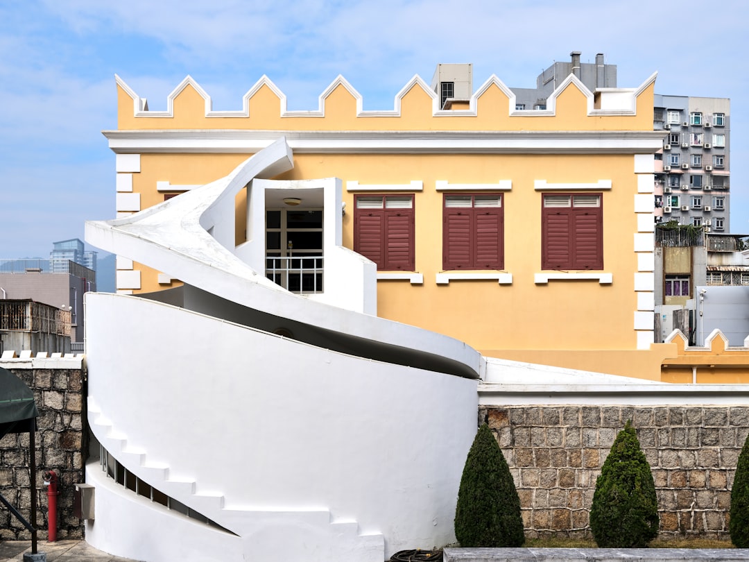 Stunning, modern architectural home with large windows overlooking a calm ocean, representing a valuable coastal asset.